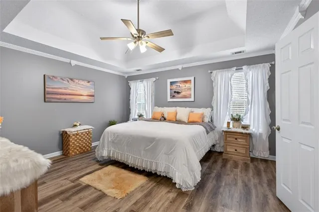 a bedroom with a bed mirror on desk and a window