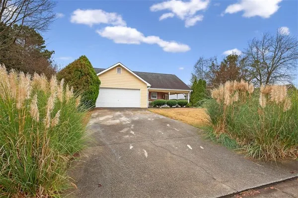 a view of backyard of house and green space