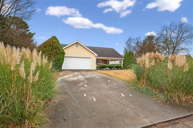 a view of backyard of house and green space