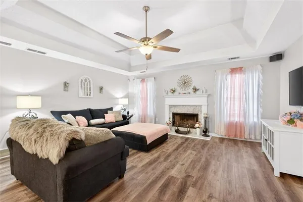 a bedroom with a bed a chandelier couch and a window
