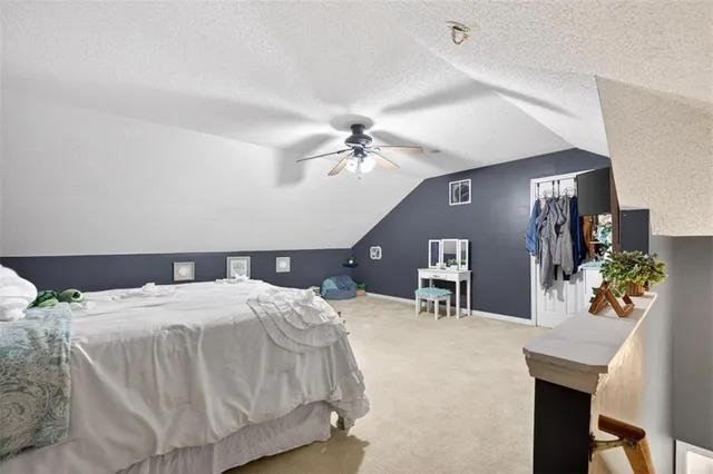a spacious bedroom with a bed and a chandelier