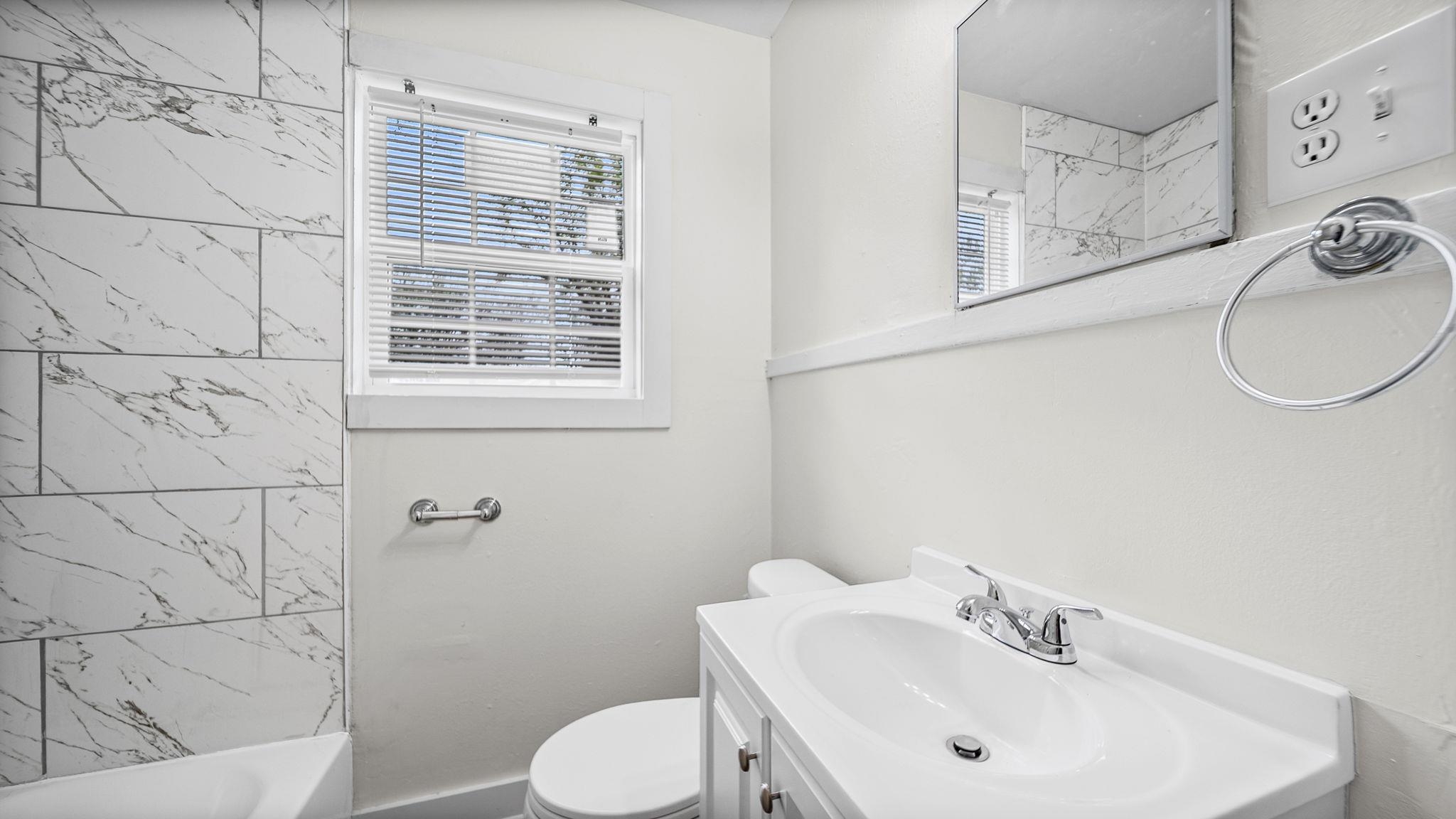 4408 Given Avenue Memphis, TN 38122 - Photo 13 of 16 a bathroom with a sink a toilet and shower