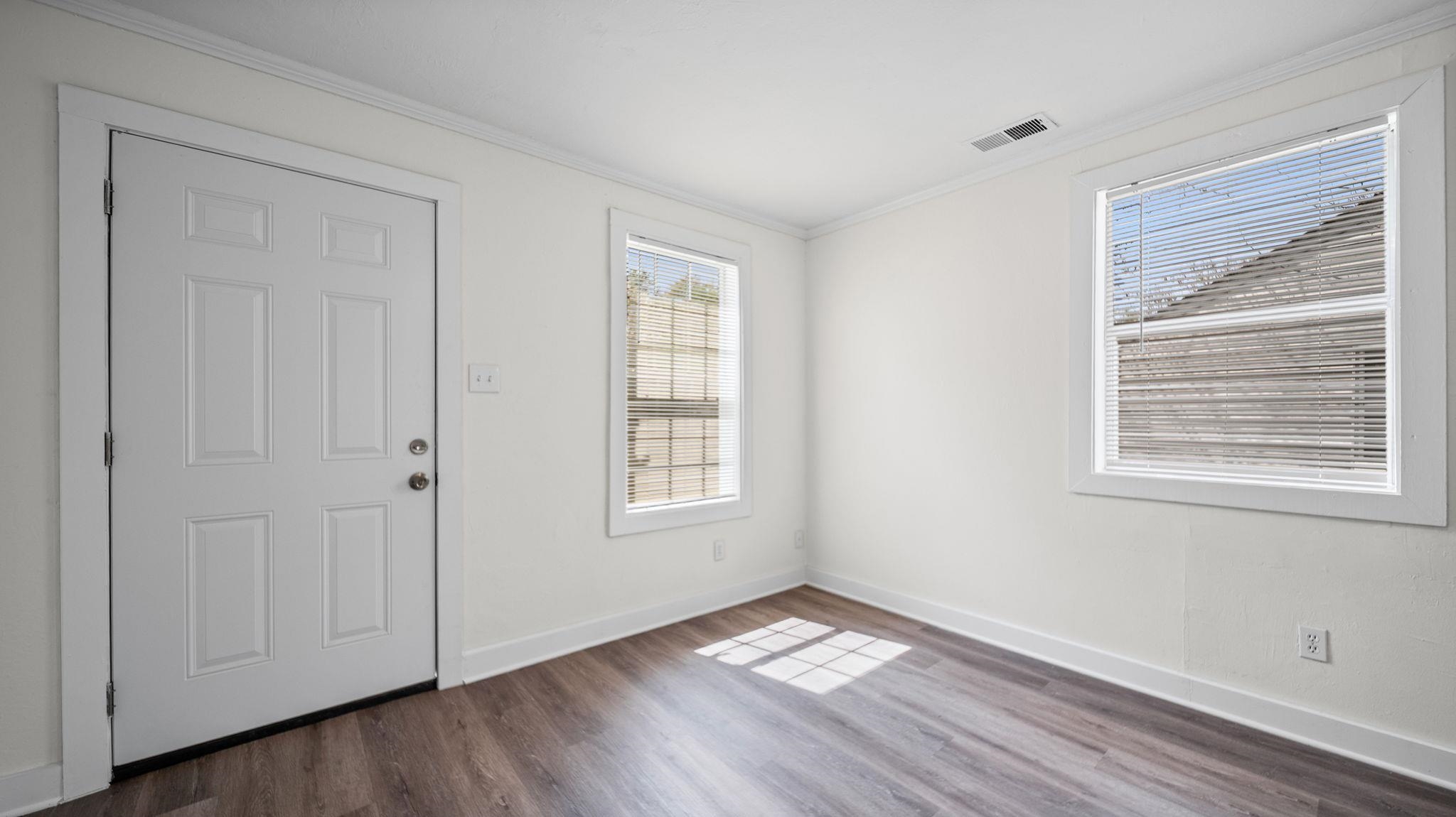 4408 Given Avenue Memphis, TN 38122 - Photo 4 of 16 a view of an empty room with wooden floor and a window