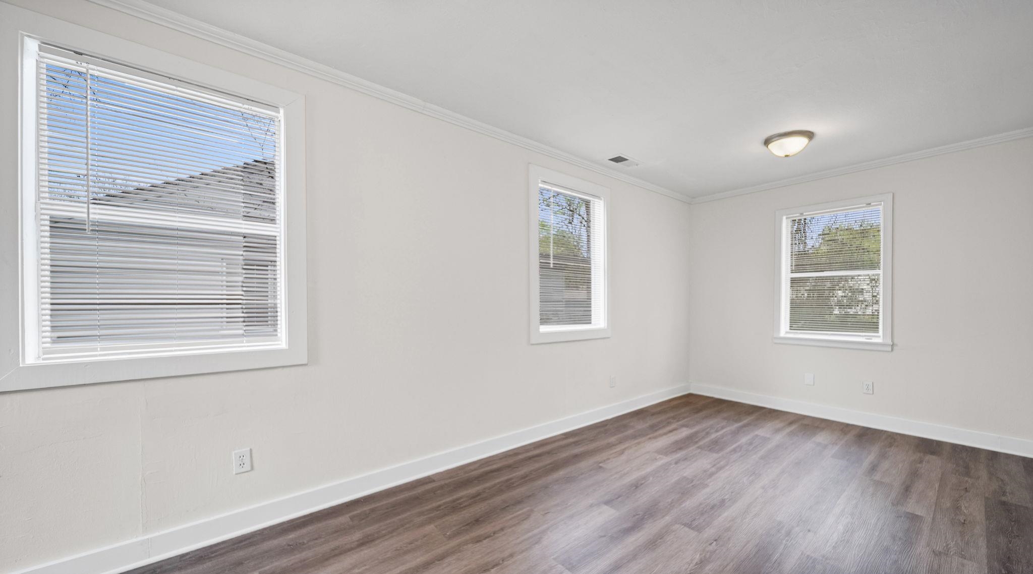 4408 Given Avenue Memphis, TN 38122 - Photo 5 of 16 a view of an empty room with wooden floor and a window