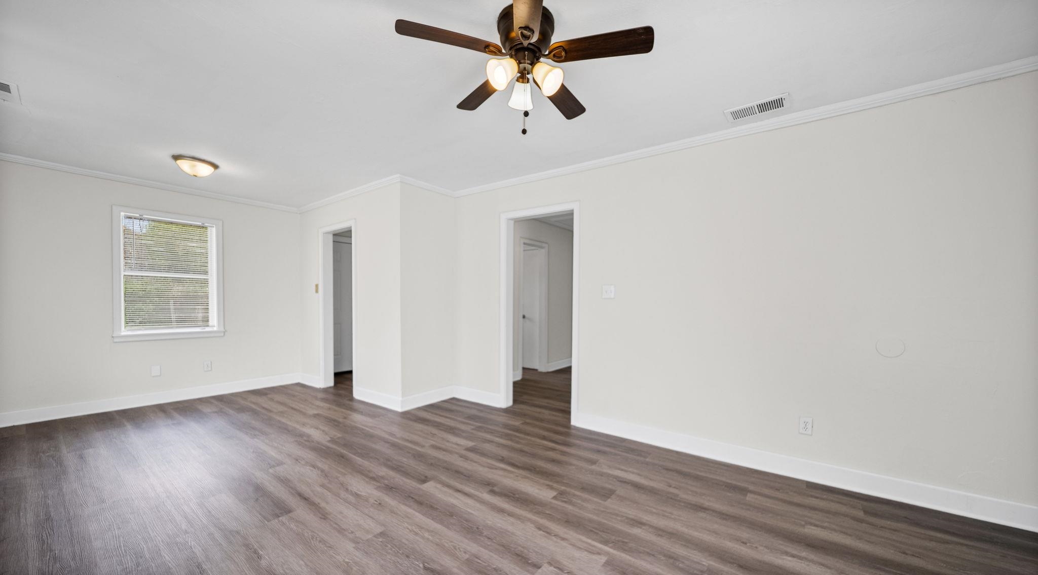 4408 Given Avenue Memphis, TN 38122 - Photo 6 of 16 a view of a room with wooden floor ceiling fan and window