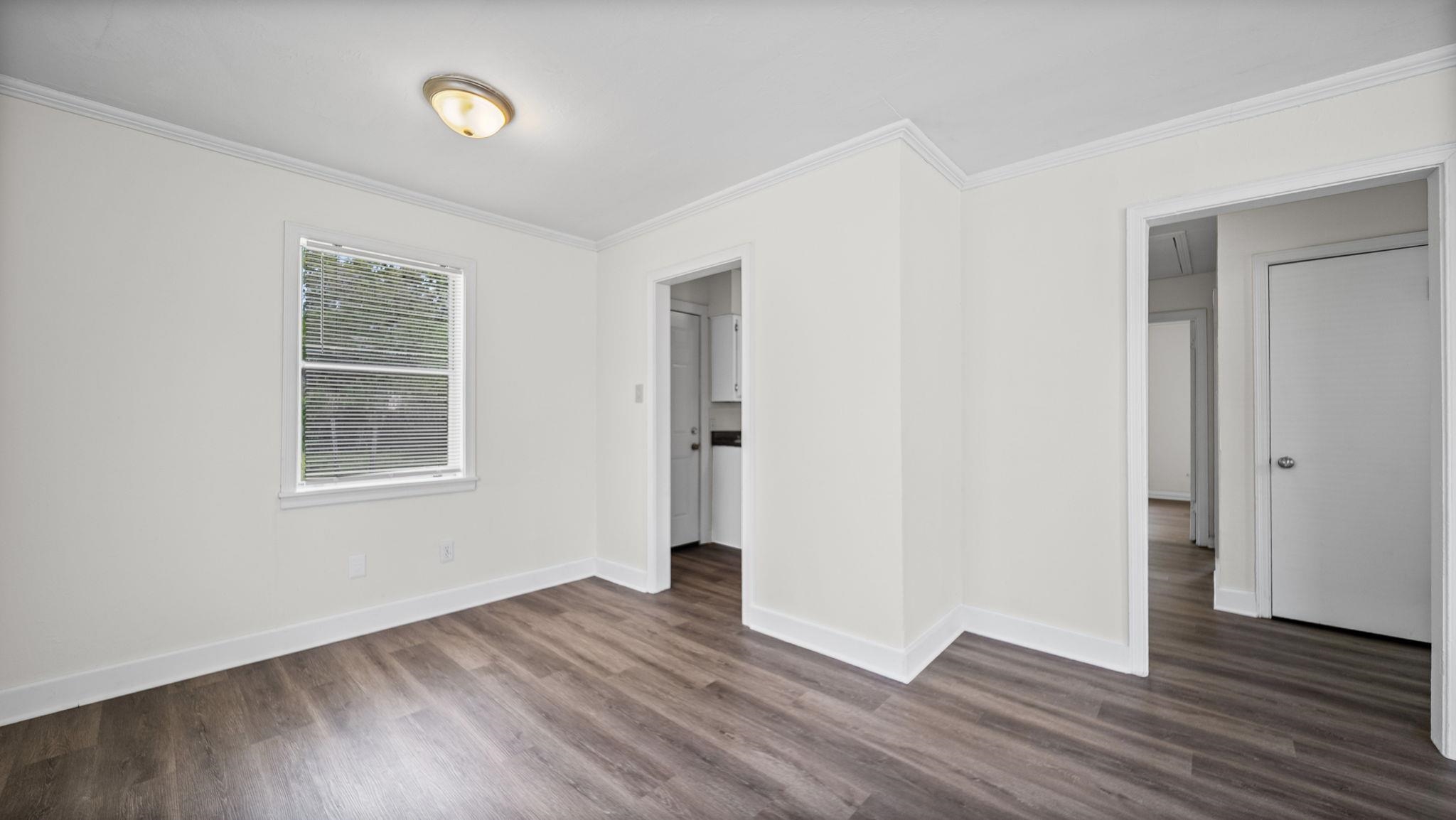 4408 Given Avenue Memphis, TN 38122 - Photo 8 of 16 an empty room with wooden floor and windows
