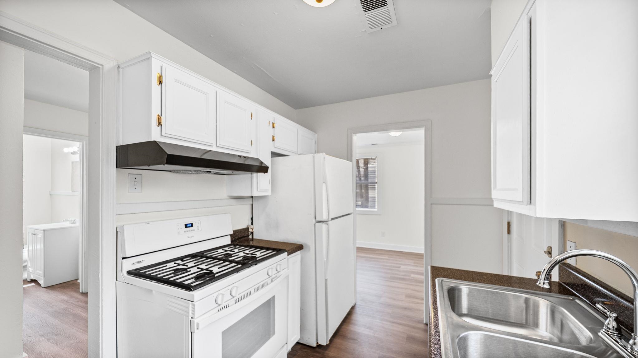 4408 Given Avenue Memphis, TN 38122 - Photo 9 of 16 a kitchen with stainless steel appliances a stove a refrigerator and cabinets