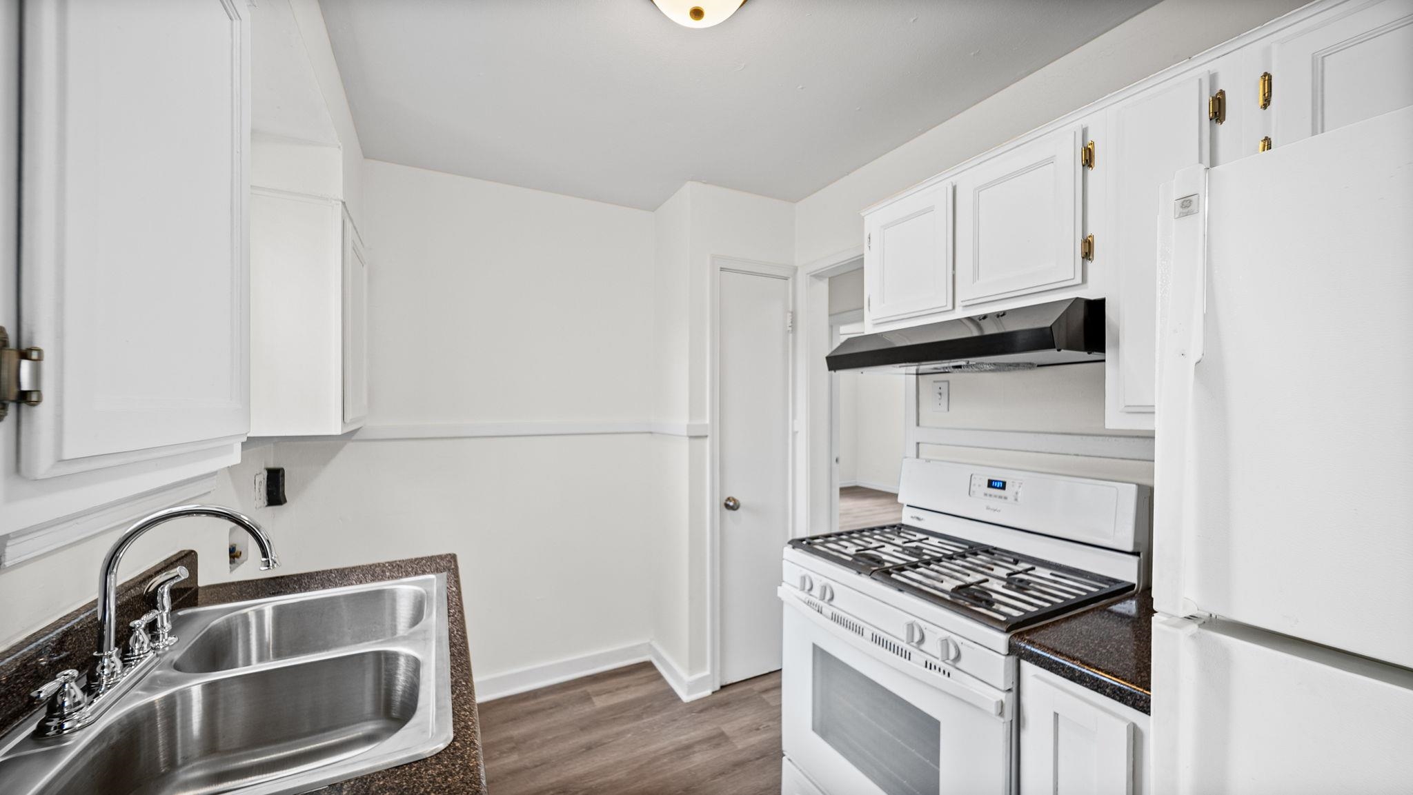 4408 Given Avenue Memphis, TN 38122 - Photo 10 of 16 a kitchen with white cabinets and appliances