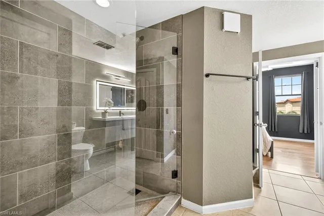 a bathroom with a sink mirror and toilet