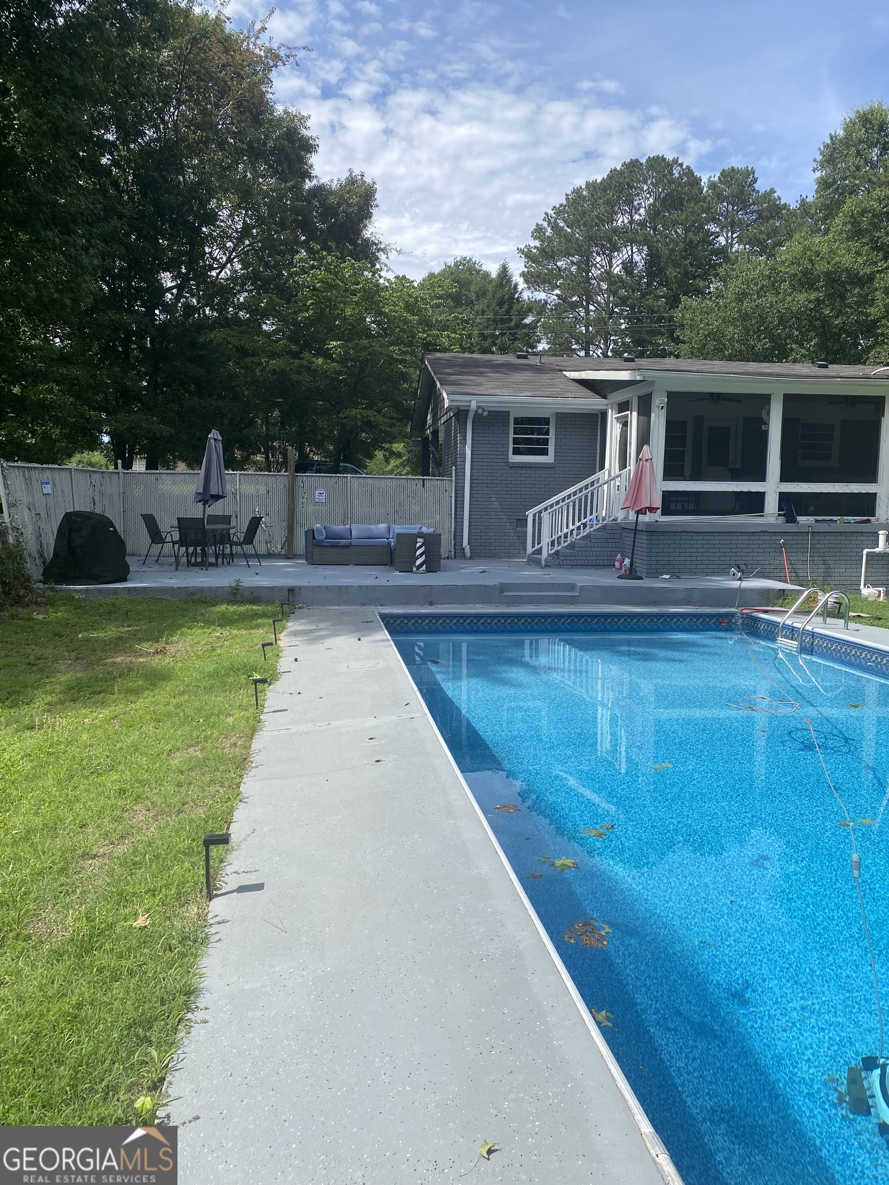 7383 Pleasant Hill Road Lithonia, GA 30058 - Photo 17 of 18 a view of a house with swimming pool