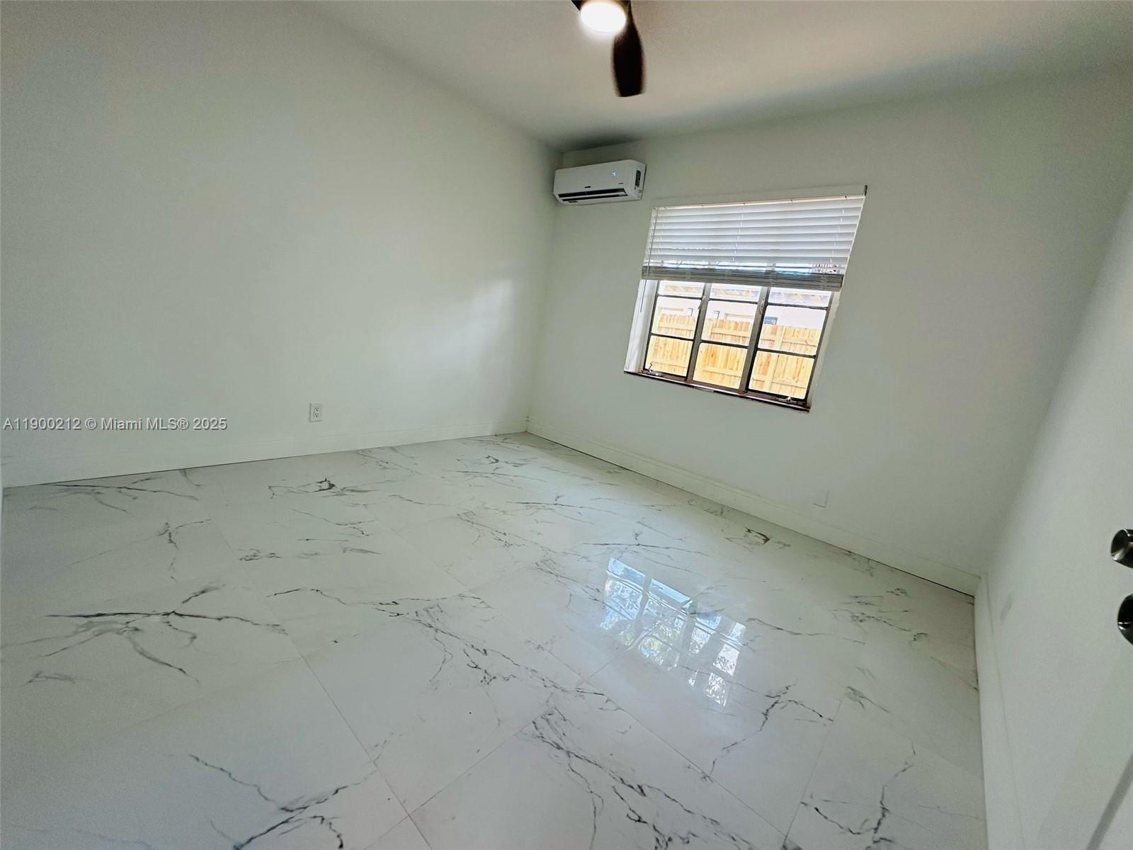 407 Southeast 14th Court, Unit 2 Fort Lauderdale, FL 33316 - Photo 7 of 16 an empty room with a empty space and windows