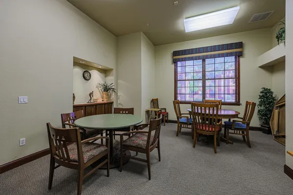 a view of a dining room with furniture and window
