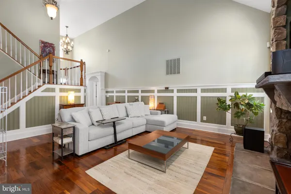 a kitchen with stainless steel appliances granite countertop wooden cabinets a sink and dishwasher a stove with wooden floor
