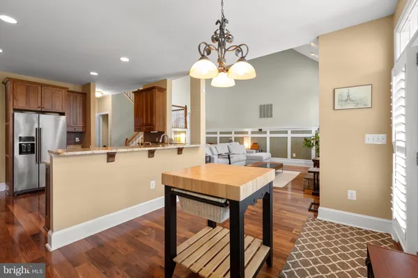 a kitchen with stainless steel appliances kitchen island granite countertop a refrigerator sink and stove