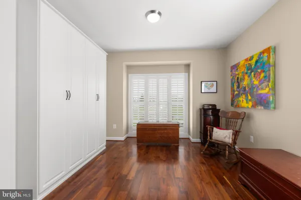 a bedroom with a large bed and a large window