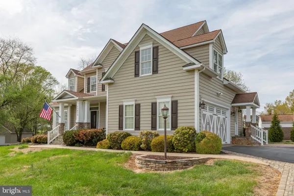 a view of a house with a big yard and garden