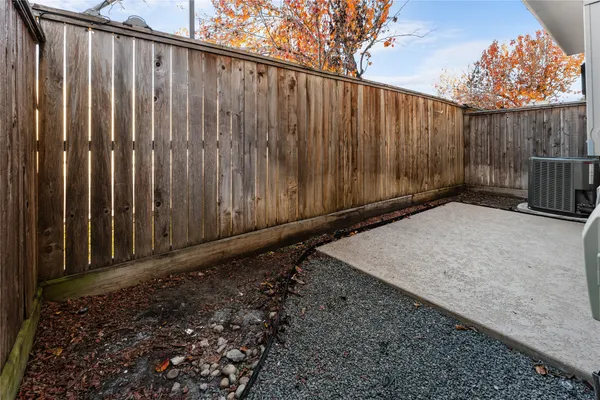 a view of a wooden fence with a large trees