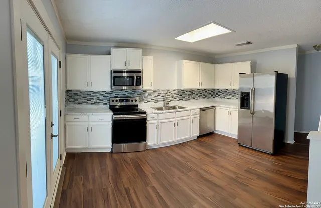 a kitchen with a stove a sink and a refrigerator