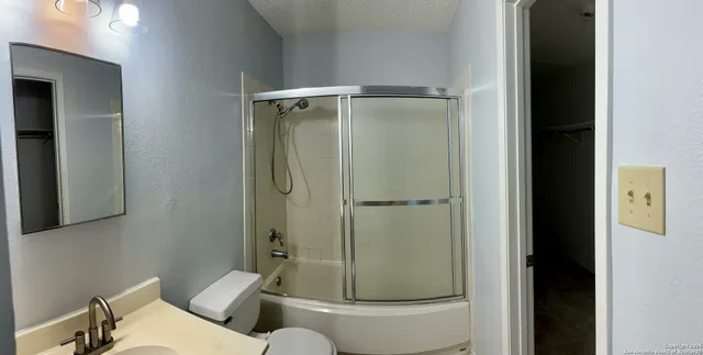 a bathroom with a toilet and shower