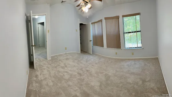 an empty room with windows and closet