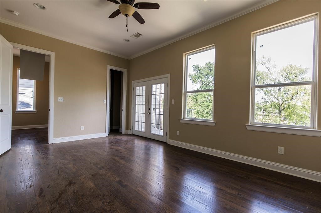 1424 Eddington Street Houston, TX 77023 - Photo 9 of 14 a view of an empty room with a window and wooden floor