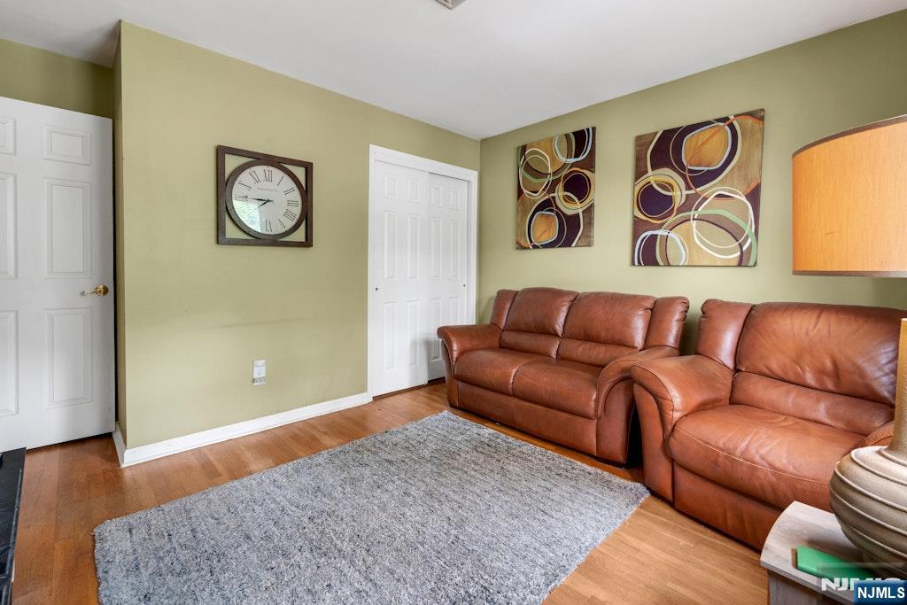 185 Ratzer Road Wayne, NJ 07470 - Photo 25 of 36 a blue couch sitting in a living room with a rug