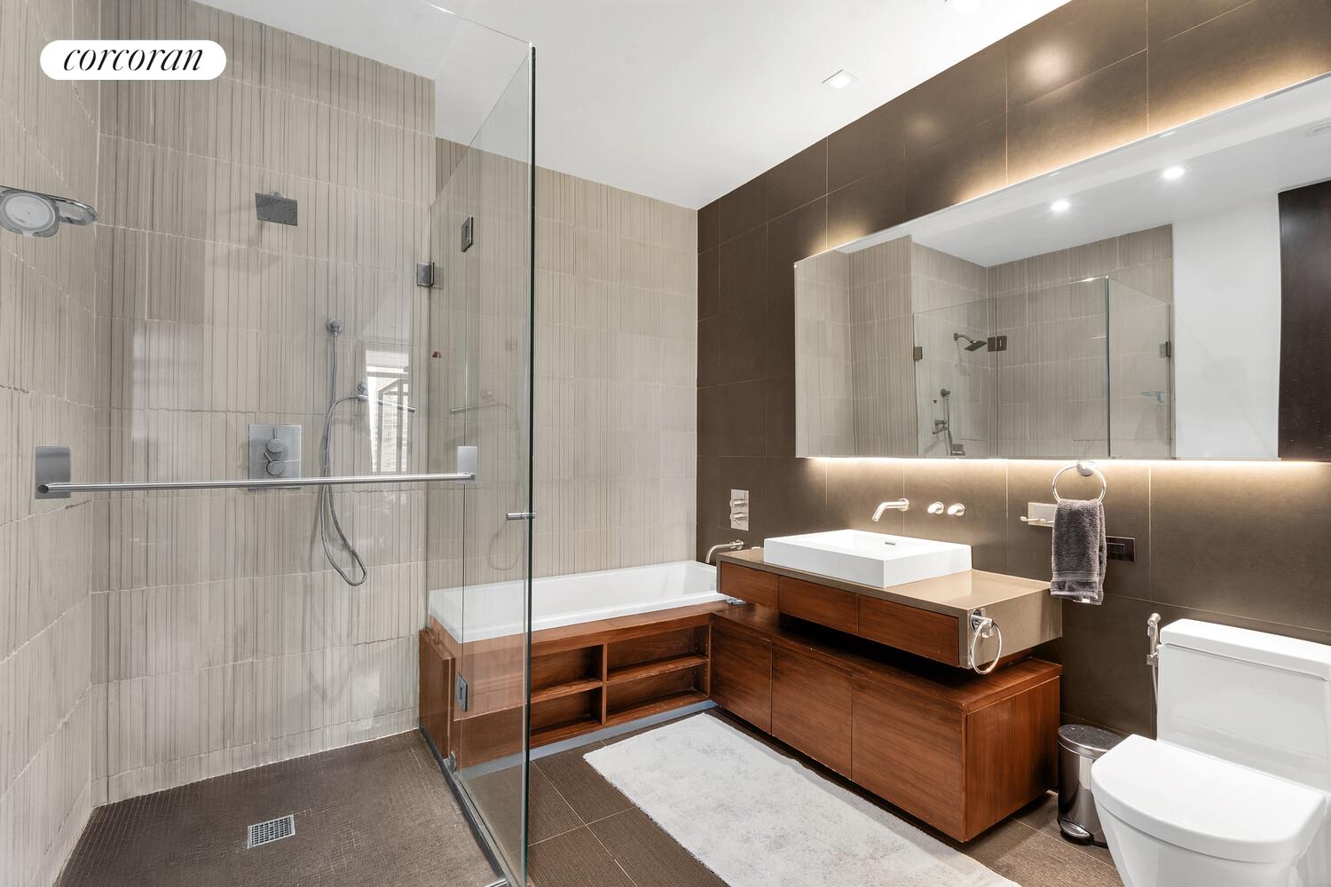 252 7th Avenue, Unit 16J Manhattan, NY 10001 - Photo 5 of 8 a bathroom with a double vanity sink toilet and shower