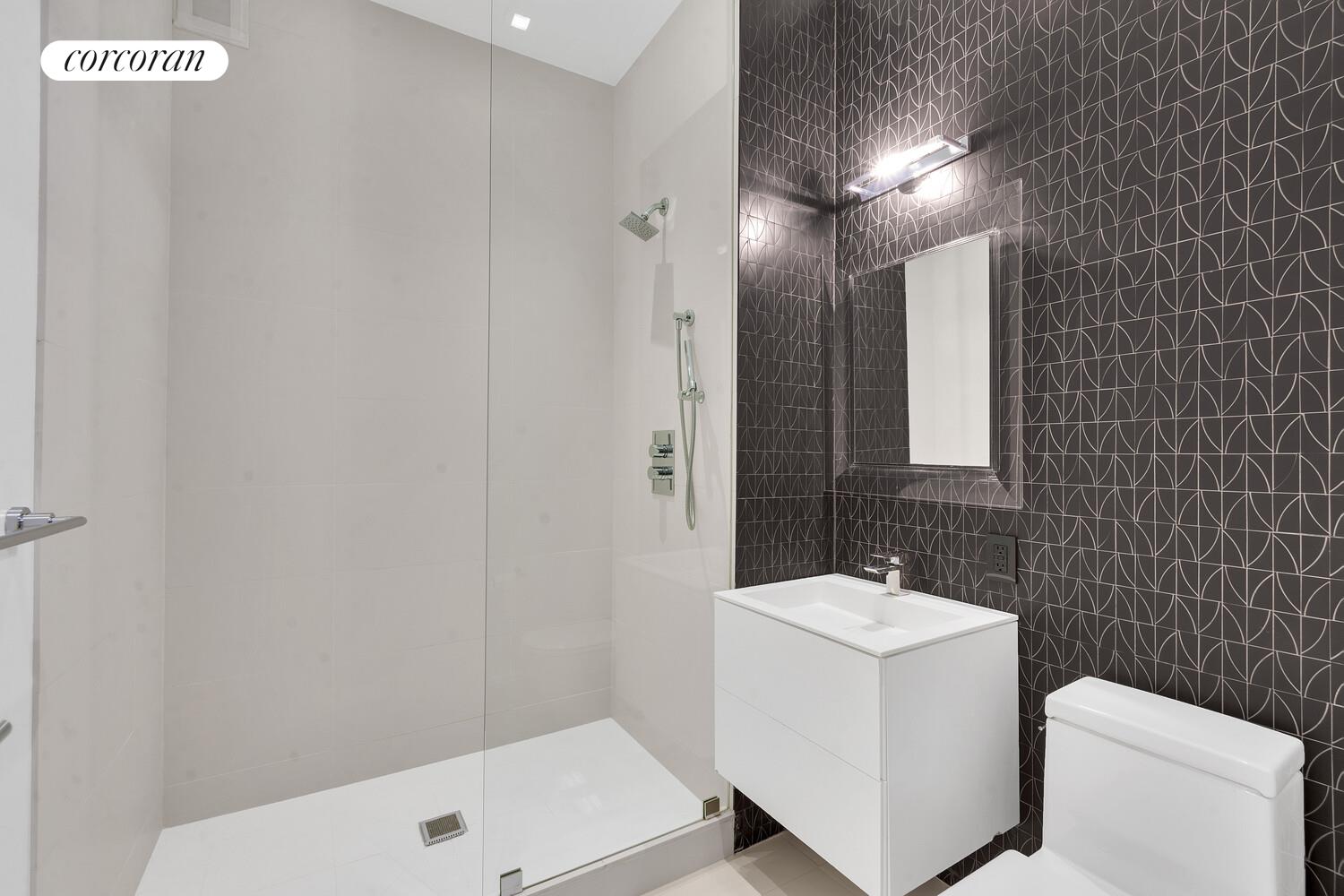 252 7th Avenue, Unit 16J Manhattan, NY 10001 - Photo 7 of 8 a bathroom with a sink a toilet and a mirror