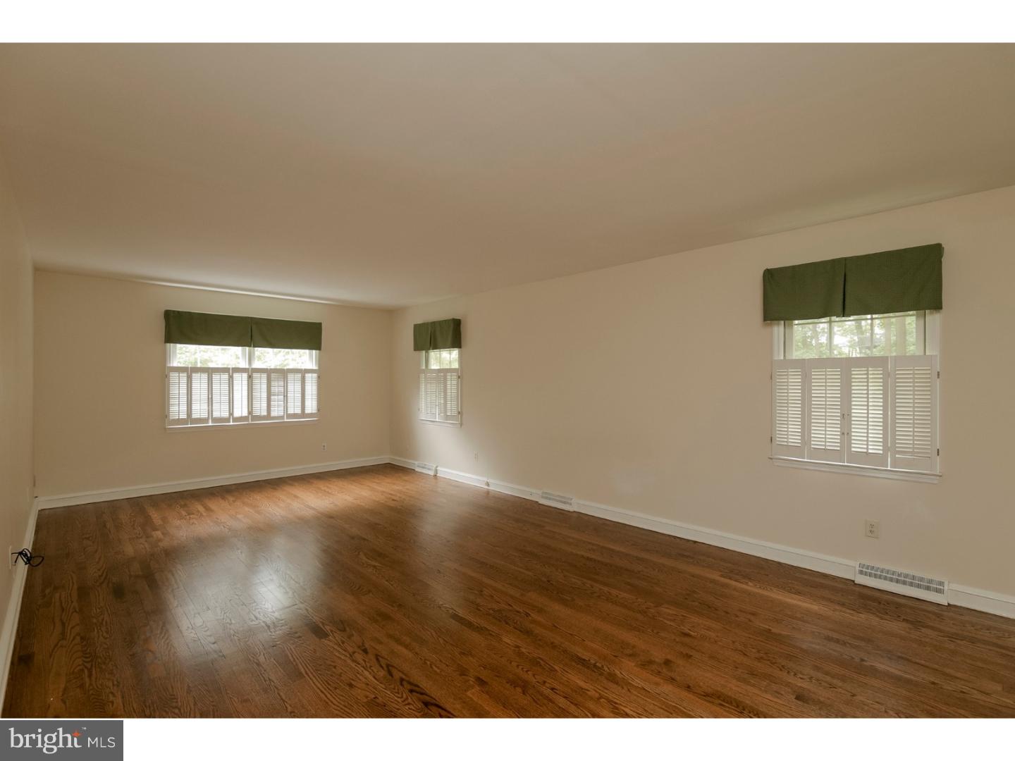 102 South Spring Valley Road Wilmington, DE 19807 - Photo 11 of 25 a view of an empty room with wooden floor and a window