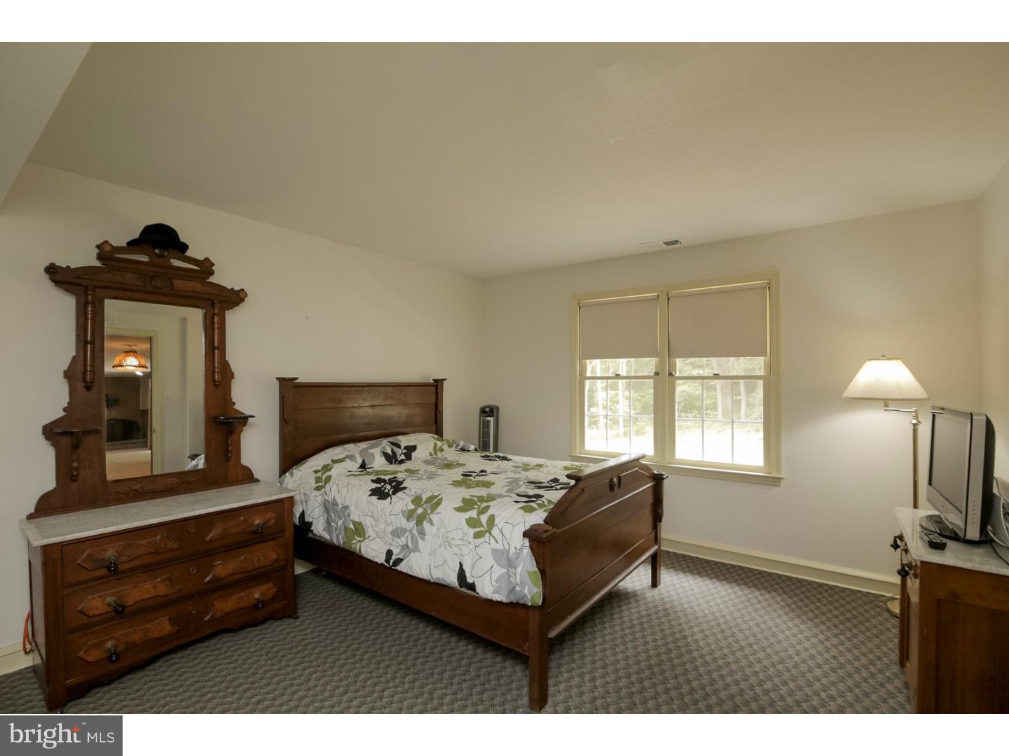 102 South Spring Valley Road Wilmington, DE 19807 - Photo 21 of 25 a bedroom with a bed and a mirror on dresser