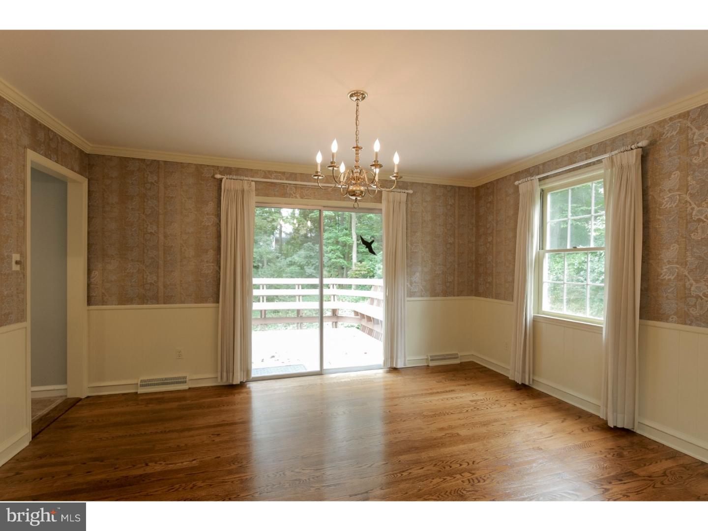 102 South Spring Valley Road Wilmington, DE 19807 - Photo 7 of 25 an empty room with wooden floor and windows