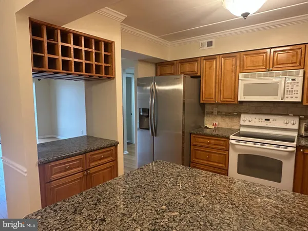 a kitchen with stainless steel appliances a stove and a refrigerator