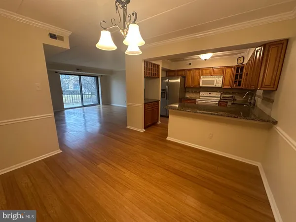 a view of a kitchen with a sink and wooden floor