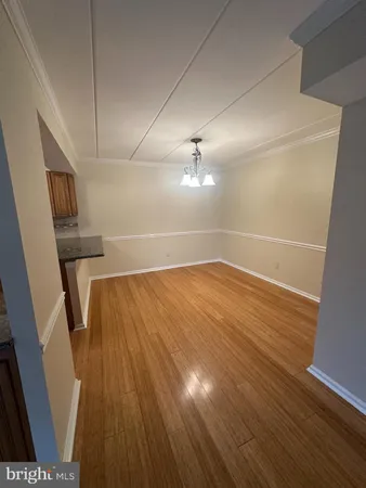 wooden floor in an empty room with a mirror