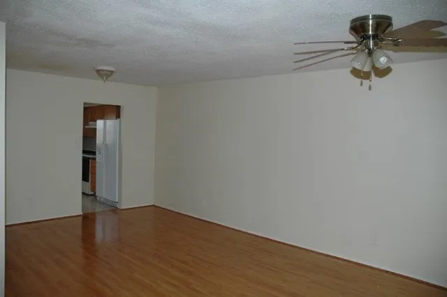 a view of a room with wooden floor