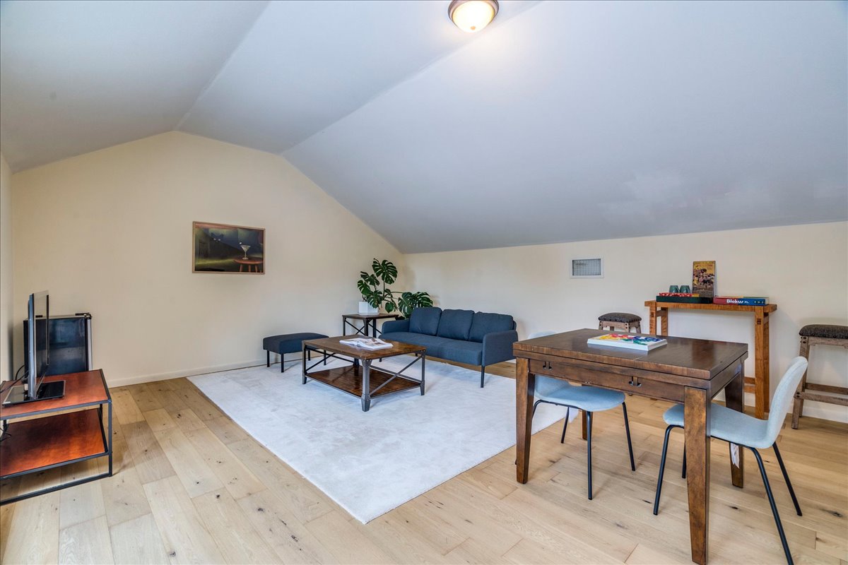 3012 South 4th Street, Unit B Austin, TX 78704 - Photo 25 of 40 Expansive attic space featuring light wood-finish flooring, a neutral color palette, and a sloped ceiling