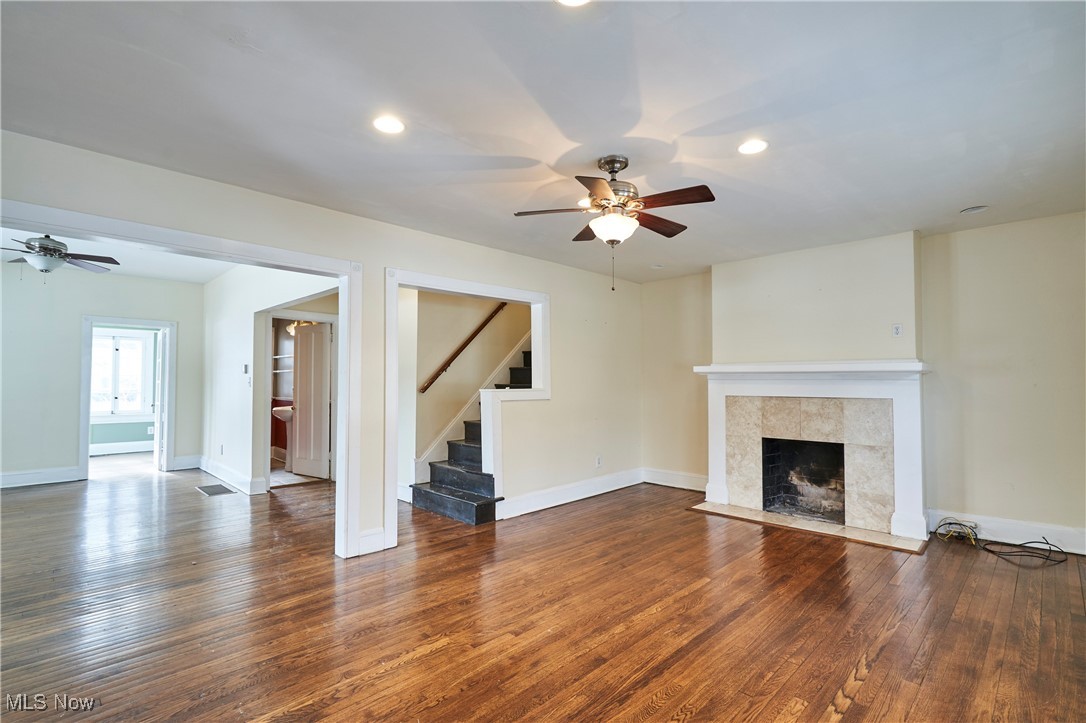 2152 Middlefield Road Cleveland, OH 44106 - Photo 6 of 50 Unfurnished living room with a tile fireplace, dark wood-type flooring, and ceiling fan