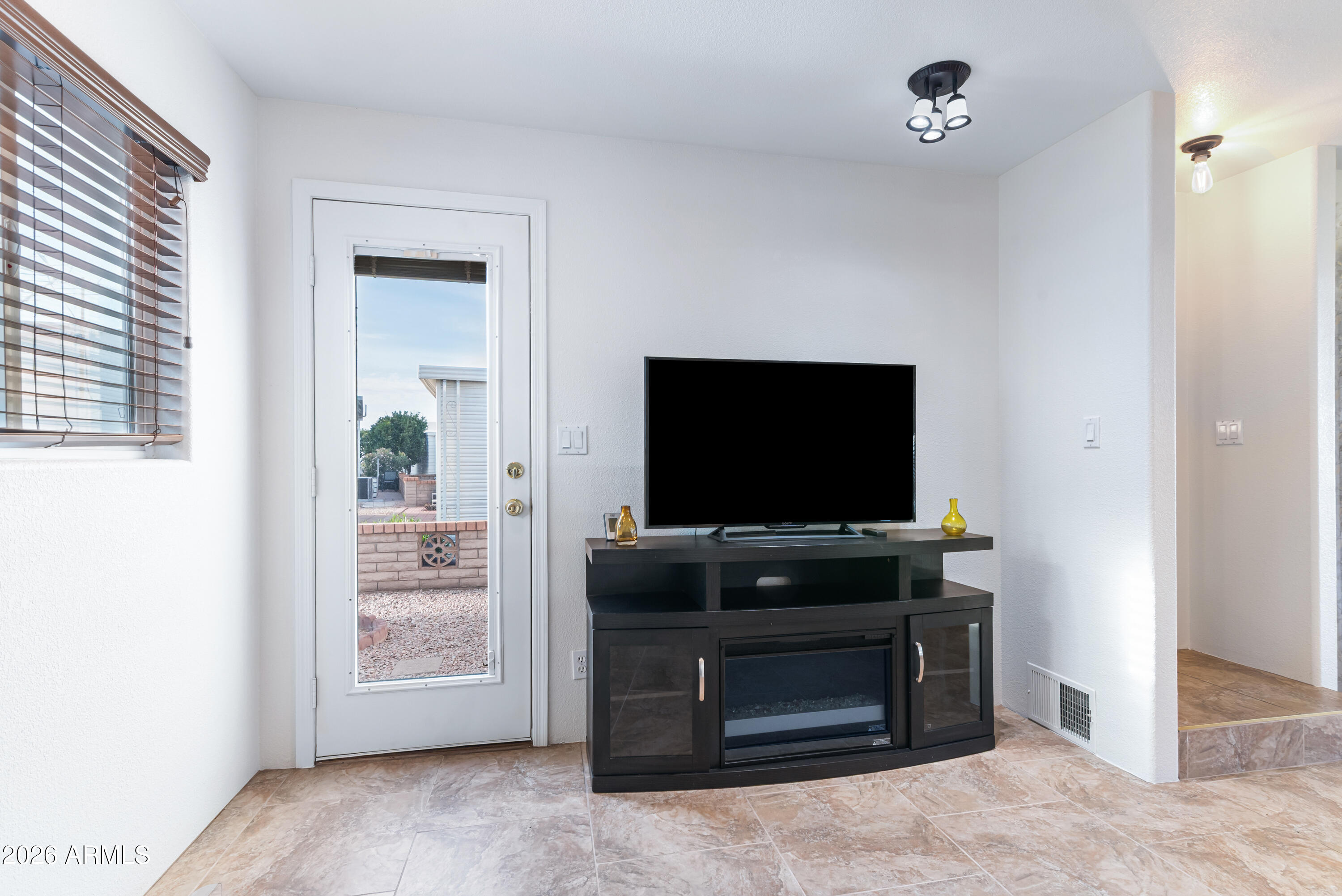 111 South Greenfield Road, Unit 547 Mesa, AZ 85206 - Photo 25 of 38 a living room with flat screen tv and furniture