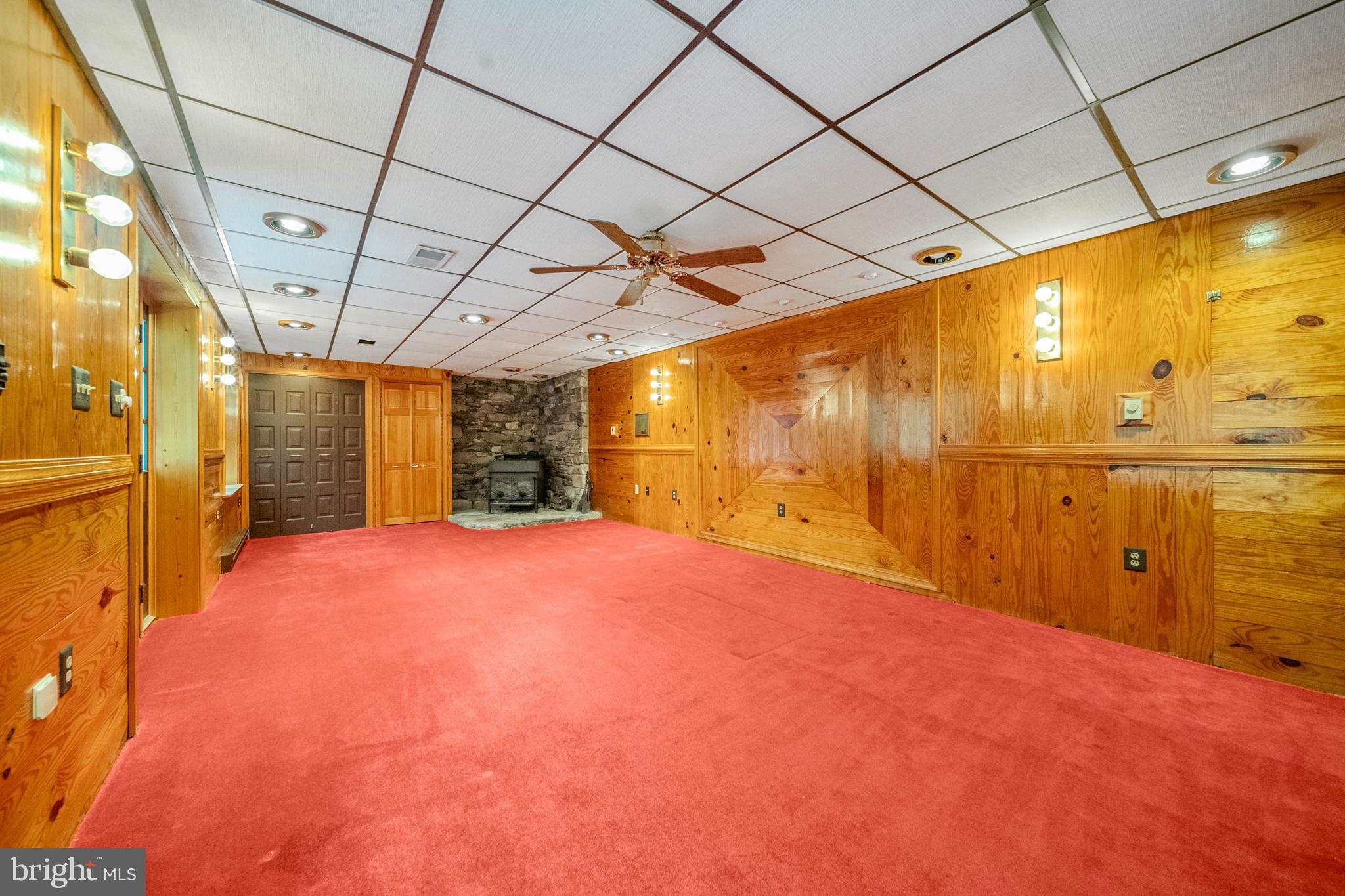 18189 Sands Road Purcellville, VA 20132 - Photo 70 of 145 Basement living room with wood stove & closets.