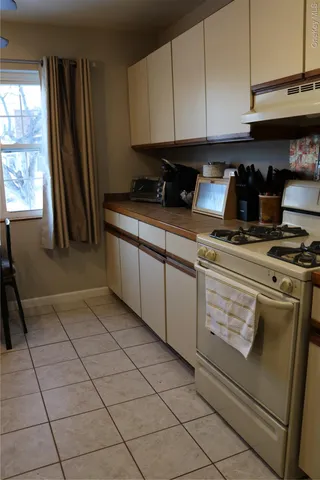 a kitchen with granite countertop cabinets and window