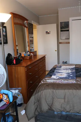 a bedroom with a bed and a chair