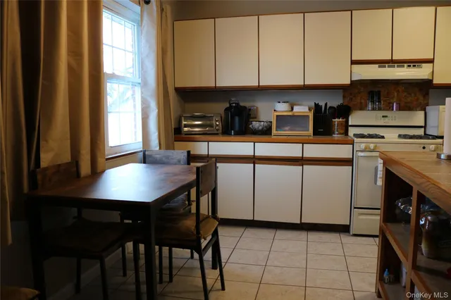 a kitchen with stainless steel appliances granite countertop a stove a refrigerator and a sink with cabinets