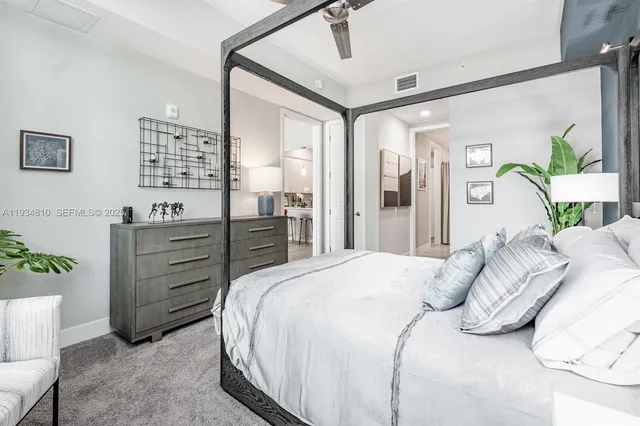 a bedroom with a bed and a dresser