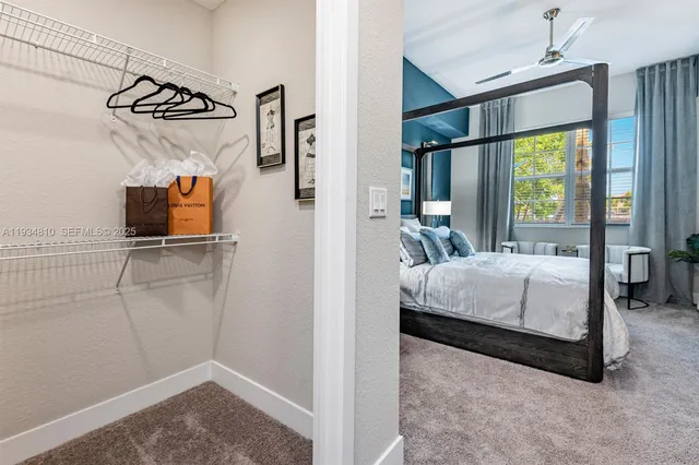 a bedroom with a bed and a flat tv screen on the dresser