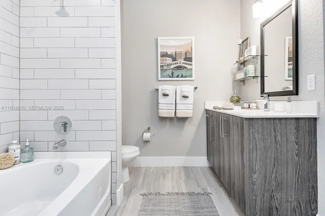 a bathroom with a sink a toilet and bathtub