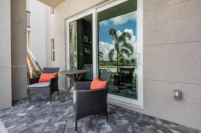 a outdoor space with patio couch and a potted plant