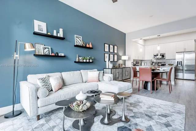 a living room with furniture a rug and a bookshelf