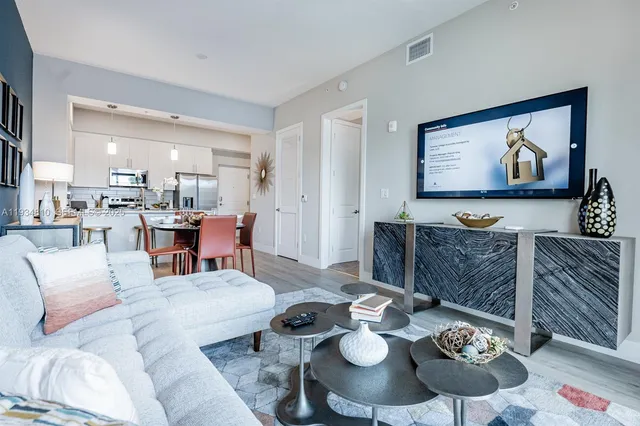 a living room with furniture and wooden floor