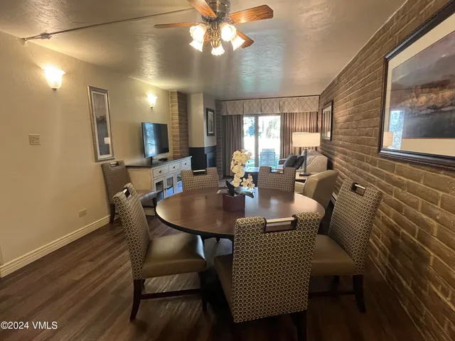 a view of a a dining room with furniture window and wooden floor