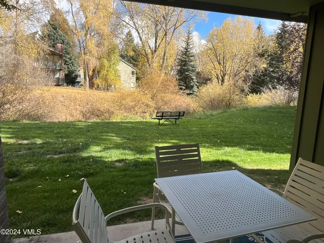 a view of a chairs and table in the garden